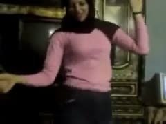 In a moment from a homemade film, a pretty Arab girl dances in front of the camera.